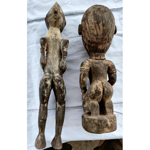 172 - Two carved wood African tribal figures of a woman height 46cm and 39cm