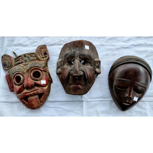 176 - Three various carved wooden masks