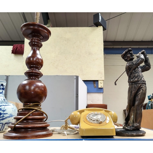 22 - A large bronzed resin figure of a golfer in swing; a large turned wood lamp; a vintage telephone