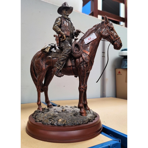 43 - A figure of John Wayne on horseback, and others related