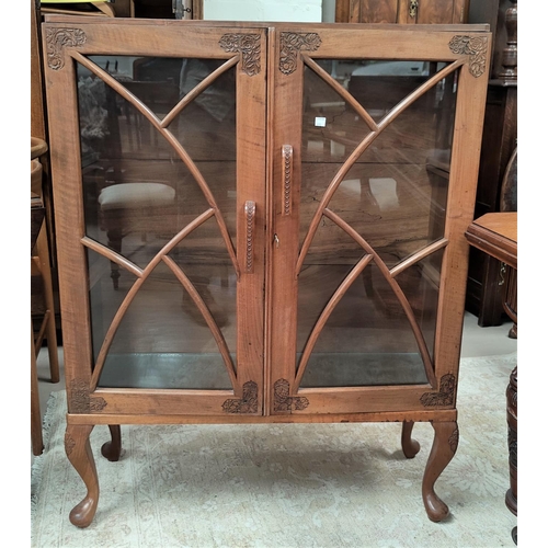 695 - An oriental small display cabinet in carved walnut, with 2 doors