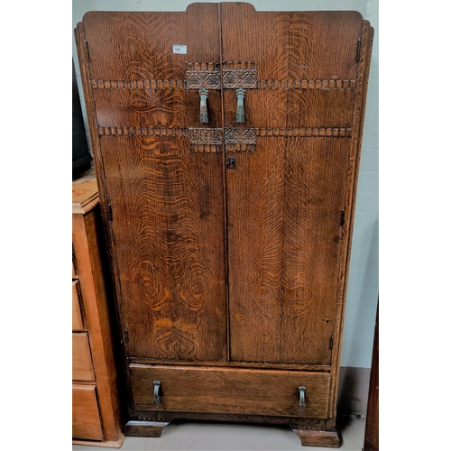 700 - A 1930's oak tallboy with double door fitted section and drawer under