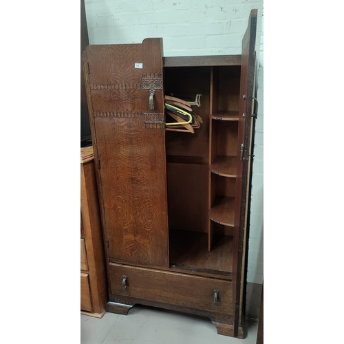 700 - A 1930's oak tallboy with double door fitted section and drawer under