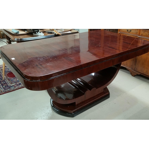 709 - An Art Deco dining suite comprising rounded rectangular table with ebonised mouldings on 'U' shaped ... 