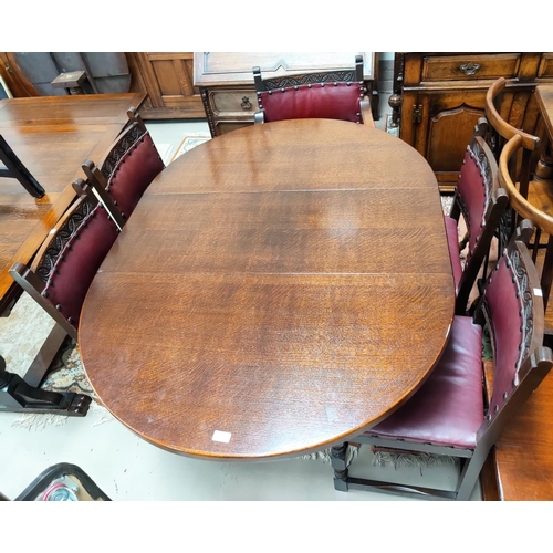723 - A Jacobean style oak dining suite comprising oval drop leaf table and 6 (4+2) chairs with carved top... 