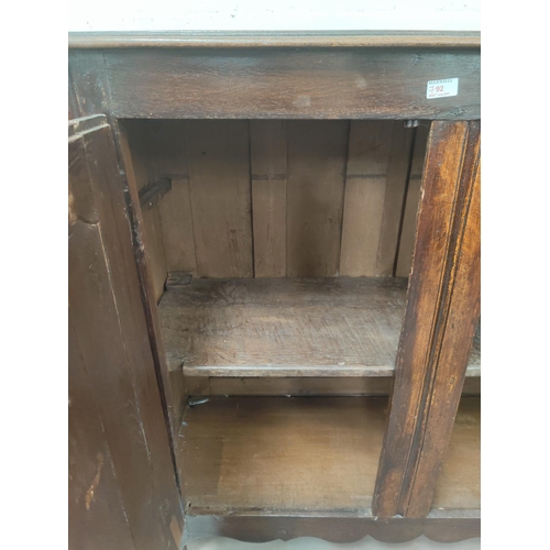 792 - An 18th/19th century oak panelled double door dole cupboard 126x46x125 cm
(back panel a.f)