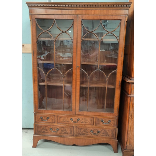 824 - A reproduction figured mahogany bookcase/display cabinet with 2 glazed doors and 5 small drawers