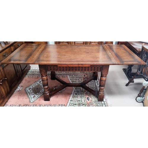 839 - An 18th century style distressed oak drawer leaf dining table in the Titchmarsh & Goodwin manner on ... 