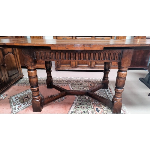 839 - An 18th century style distressed oak drawer leaf dining table in the Titchmarsh & Goodwin manner on ... 