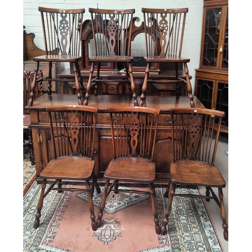 840 - An 18th century style distressed oak set of 6 Windsor style wheel back dining chairs in the Titchmar... 