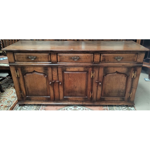 841 - An 18th century style distressed oak sideboard of 3 cupboards and 3 drawers in the Titchmarsh & Good... 