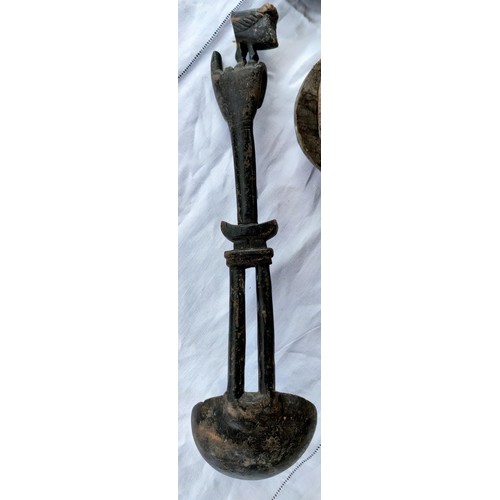 171 - A carved wooden African tribal ladle with a hand rest etc (part of terminal missing) a smaller carve... 