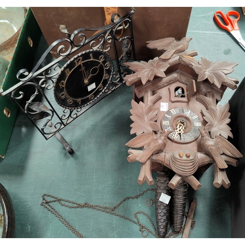 120 - A chiming mantel clock in oak case; a cuckoo clock. a mantel clock in wrought metal case