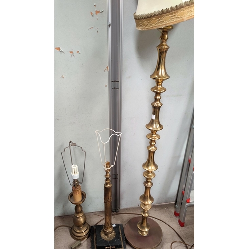 121 - A turned brass standard lamp; a similar table lamp; a marble and brass table lamp
