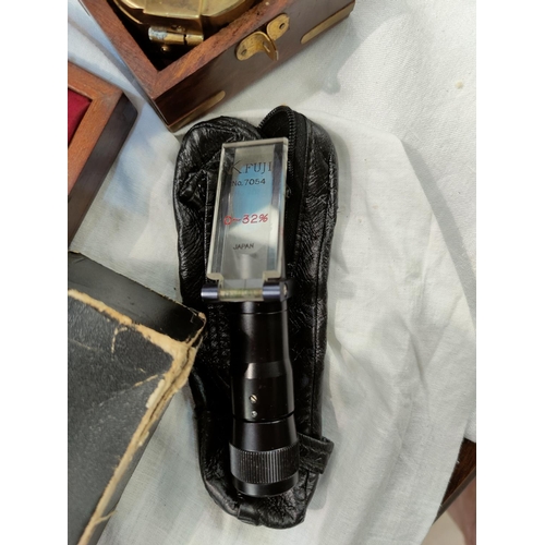 156 - A vintage wooden cased Sikes hydrometer by J.Woodley & Sons, a vintage Fuji hand refractometer and a... 