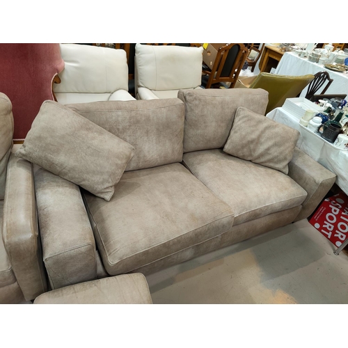 793 - A modern fawn coloured three seater settee, matching arm chair and foot stool