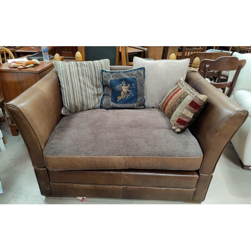 809 - A modern leather double drop arm two seater Knoll settee with rope supports and material back.