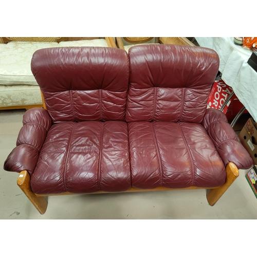 817 - A Danish two seater settee and armchair with red leather effect upholstery