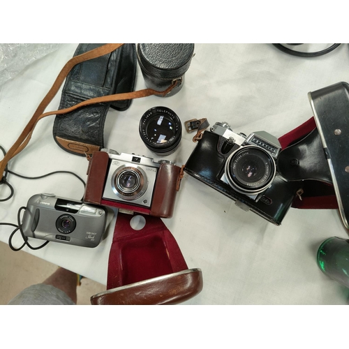 187 - A Praktica Nova B SLR camera with Carl Zeiss lens, a Zeiss Contina, a Palmer telephoto lens and anot... 