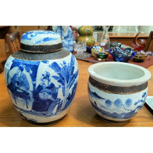 345C - A Chinese blue and white crackle glaze ginger jar showing scholars and with bark effect decoration t... 