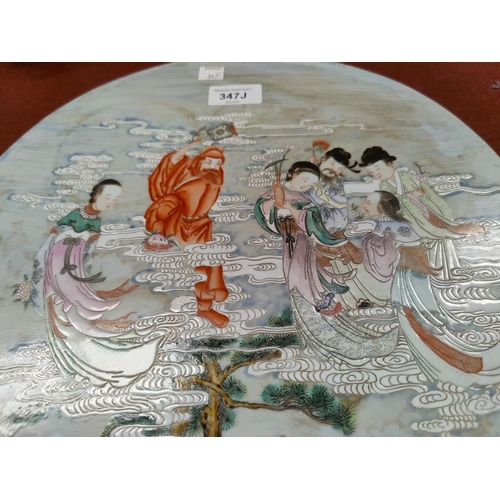 347J - A Chinse circular porcelain plaque depicting Immortals floating in clouds, diameter 34cm (some disco... 
