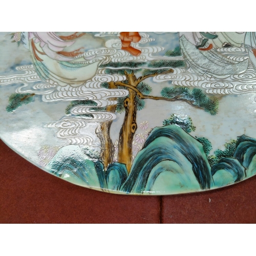 347J - A Chinse circular porcelain plaque depicting Immortals floating in clouds, diameter 34cm (some disco... 