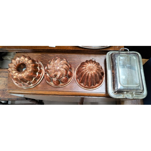 504 - A silver plated entree dish; 3 copper jelly moulds