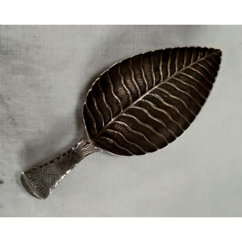 608 - A Georgian hallmarked silver caddy spoon, the bowl in the form of a leaf with monogram to the termin... 