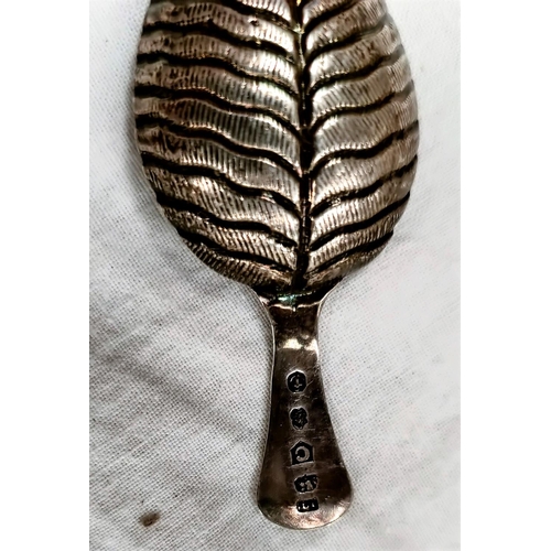 608 - A Georgian hallmarked silver caddy spoon, the bowl in the form of a leaf with monogram to the termin... 