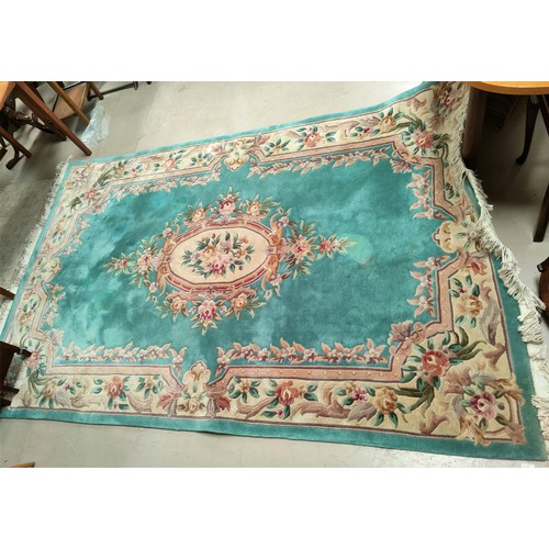 821 - A turquoise ground floral patterned Chinese carpet