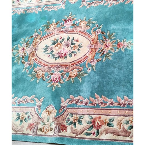 821 - A turquoise ground floral patterned Chinese carpet