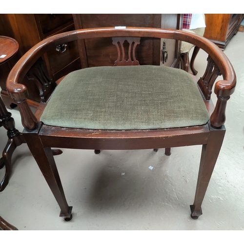 803 - An Edwardian mahogany low bow back piano stool on tapering legs with sage coloured cushion