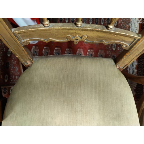 763 - An early 20th century pair of boudoir chairs reupholstered in gold; a pair of giltwood bedroom chair... 