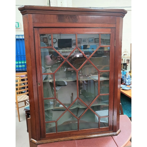 680 - A 19th century mahogany corner cupboard enclosed by single astragal glazed door