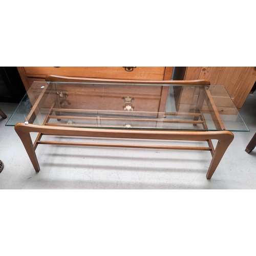 697 - A 1960's rectangular coffee table with glass top