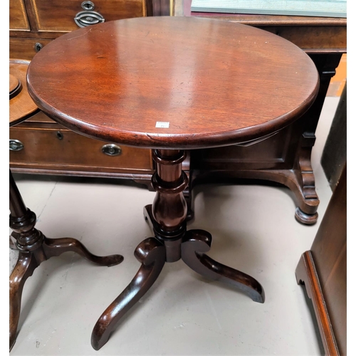 714 - A 19th century mahogany occasional table with circular top on turned column