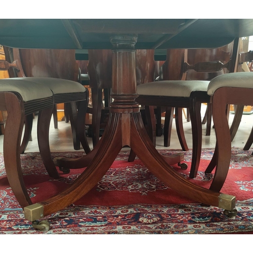 687 - A mahogany Regency style dining table with multiple satinwood crossbanding, circular top, on turned ... 