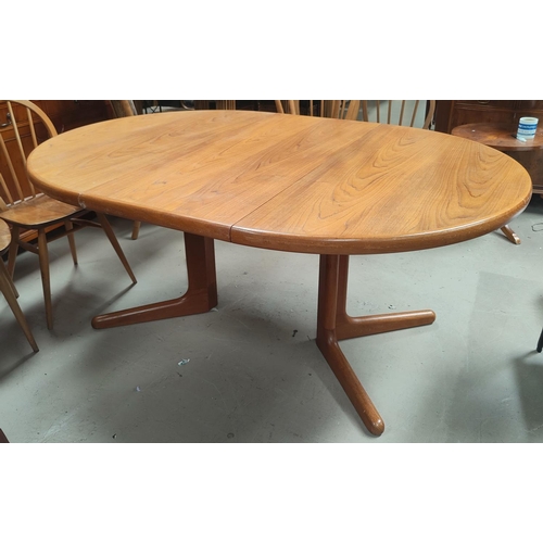 810A - A mid 20th century Danish teak circular extending dining table with 2 spare leaves, stamped A M Made... 