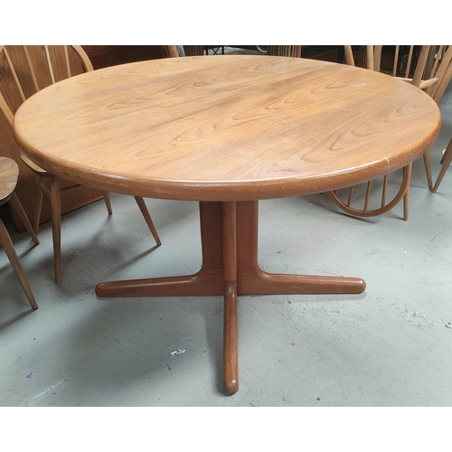 810A - A mid 20th century Danish teak circular extending dining table with 2 spare leaves, stamped A M Made... 
