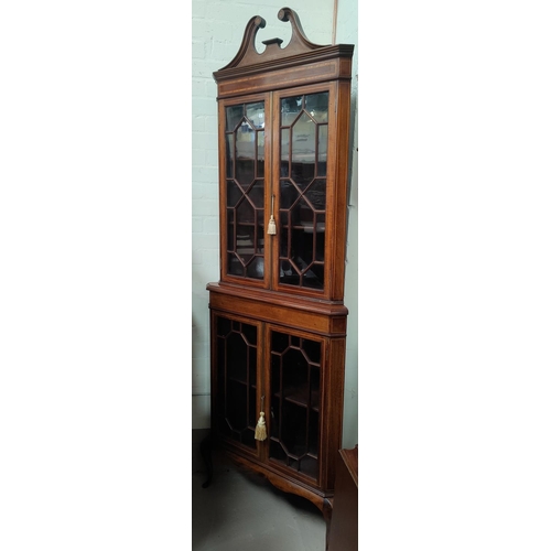 718 - An Edwardian inlaid mahogany corner display cabinet in the Sheraton style, full height, enclosed by ... 