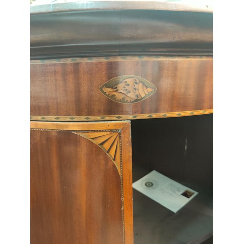 808A - A Sheraton style inlaid mahogany double door bow front corner cupboard