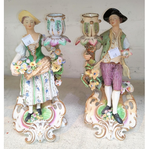 407 - A Chelsea style pair of candlesticks depicting an 18th century man and woman, height 23