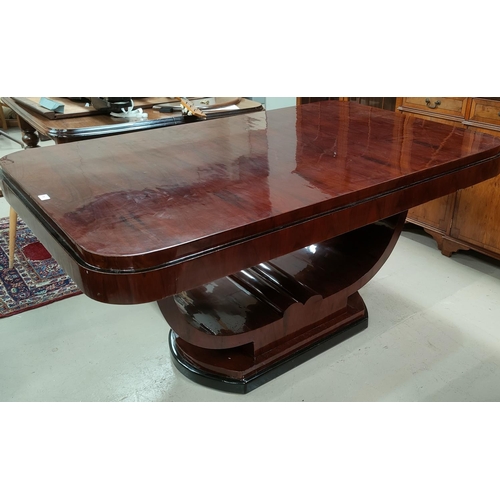 775 - An Art Deco dining suite comprising rounded rectangular table with ebonised mouldings on 'U' shaped ... 