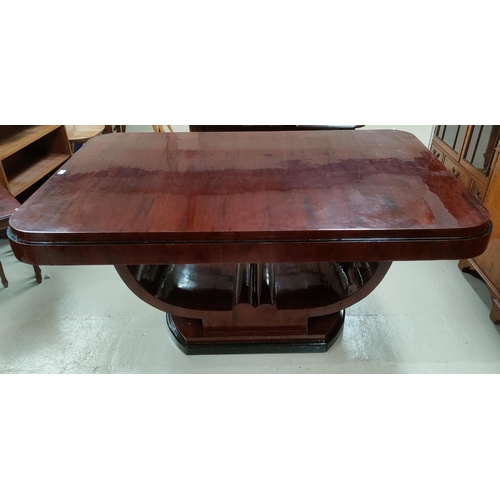 775 - An Art Deco dining suite comprising rounded rectangular table with ebonised mouldings on 'U' shaped ... 