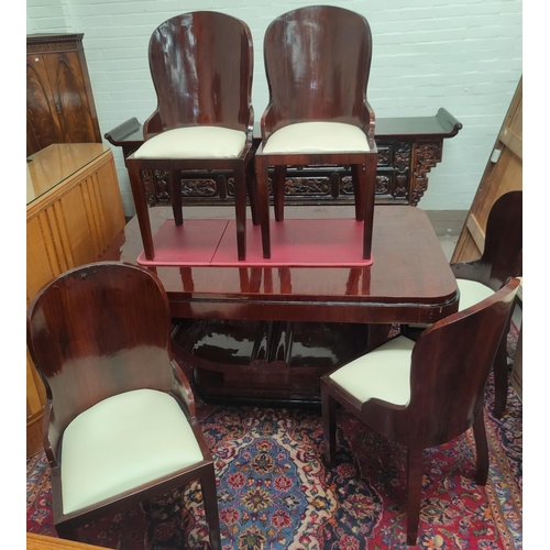 775 - An Art Deco dining suite comprising rounded rectangular table with ebonised mouldings on 'U' shaped ... 