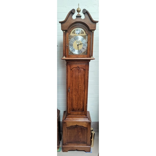 761 - A period style oak longcase clock with brass dial and fielded panel door with triple weight driven c... 