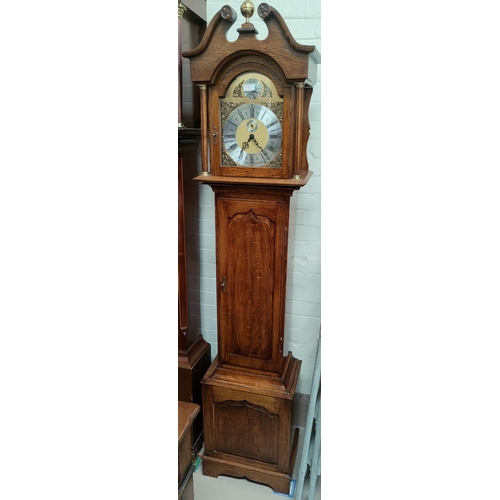 761 - A period style oak longcase clock with brass dial and fielded panel door with triple weight driven c... 