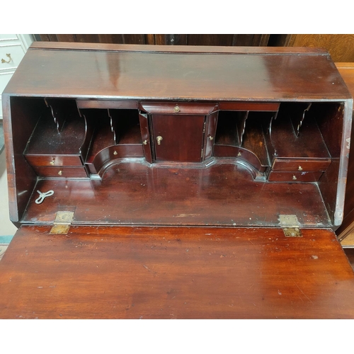 763 - A Georgian mahogany bureau with fitted interior four drawers bellow, with brass swan neck handles, w... 