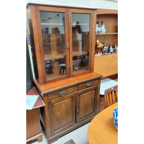 772 - An Edwardian walnut full height bookcase with 2 glazed doors over 2 cupboards and 2 drawers