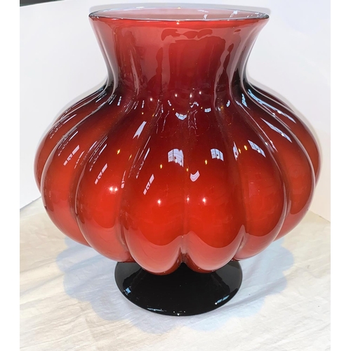 426 - Petr Novotný:  a large hand made glass vase of bulbous form in red over white, on flared foot, heigh... 